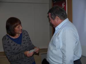 Colin presents the cheque to Marianne.